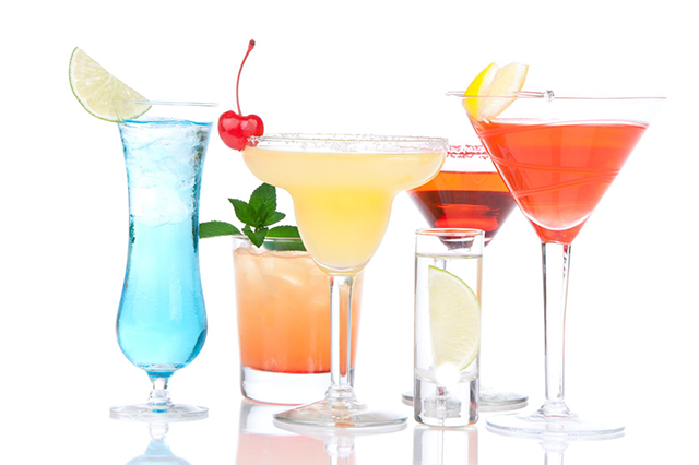 Image of variously-shaped cocktail glasses with drinks of various colours.