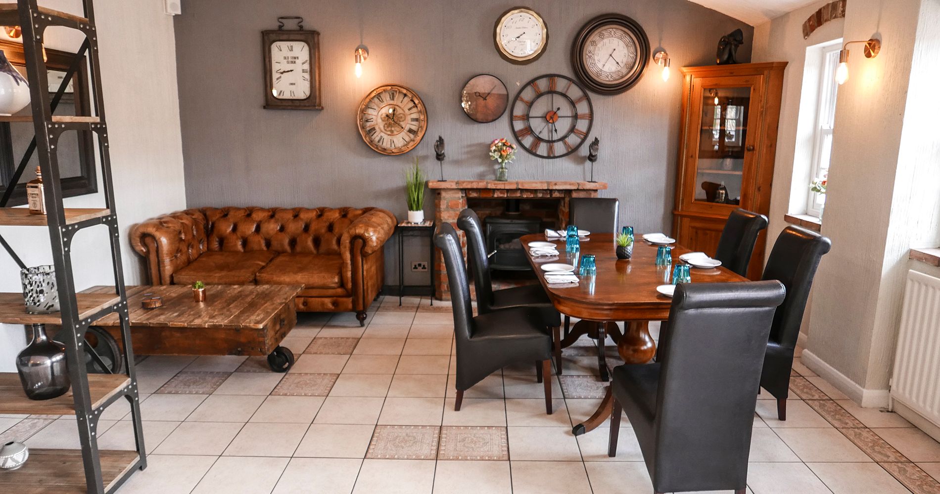Settee and restaurant table with clocks on the rear wall